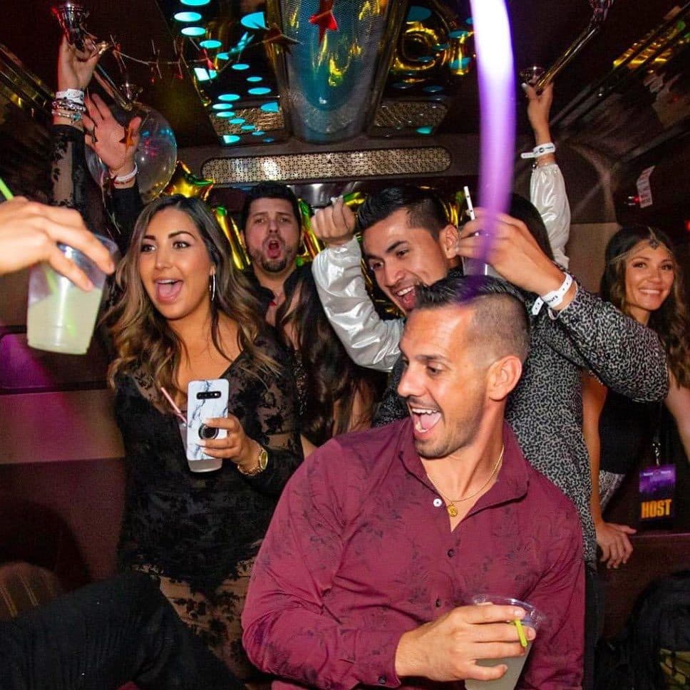 Guests toasting drinks on the party bus
